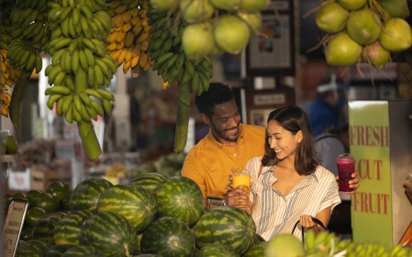 A couple explore's Robert is Here fruit stand