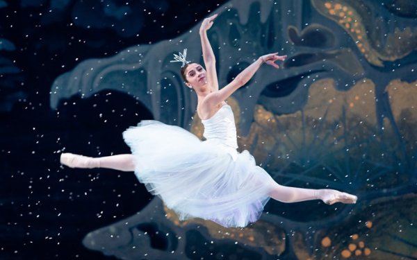 Ballerina gliding through the air at The Nutcracker® performance