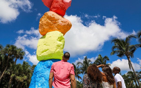 Group of friends check out the Miami Mountain on The Bass Museum lawn, by Ugo Rondinone