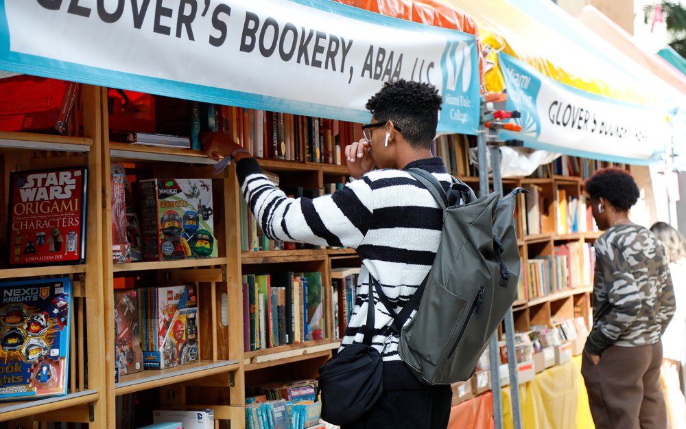 Boys browsing bookshelves at the Street Fair