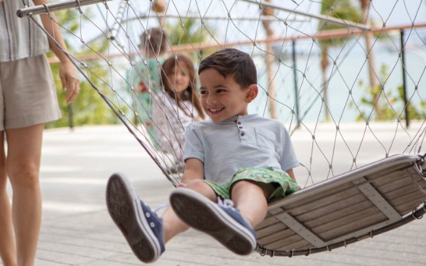 Boy on a swing at the Pérez Art Museum Miami