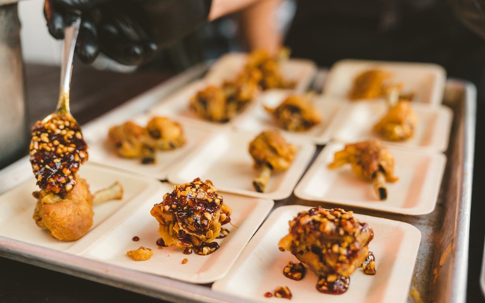 Adding sauce to food, Courtesy of SOBEWFF®️