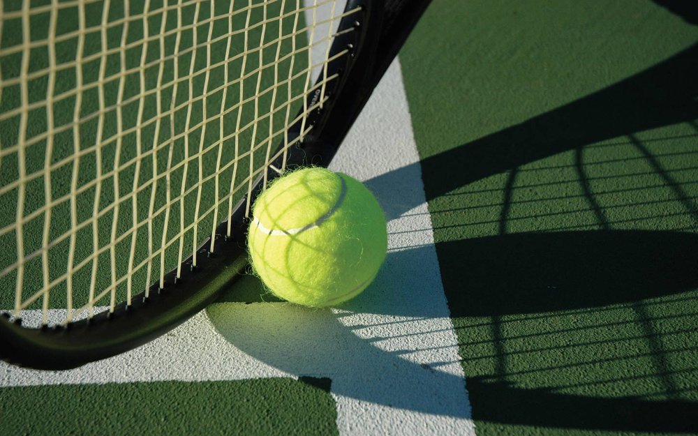 Close up of a tennis ball and racket